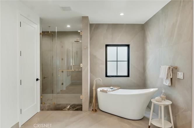 Primary bathroom with a double vanity and walk-in shower at the Gloucester Lane residence in Thousand Oaks