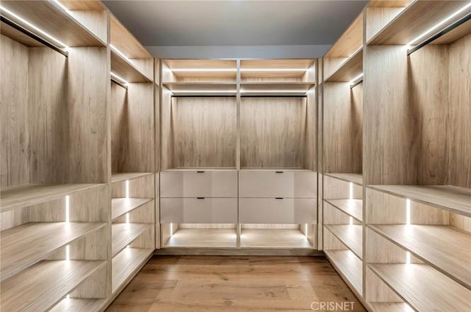 Walk-in closet with custom built-in shelving and drawers at the Gloucester Lane home in Thousand Oaks