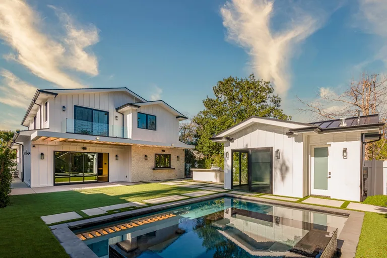 Backyard of the Beck Ave home in Studio City with a rectangular pool, lawn, covered patio and a detached guest cabana