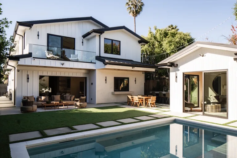 Rear yard with a pool, lawn, covered patio lounge and a detached guest cabana